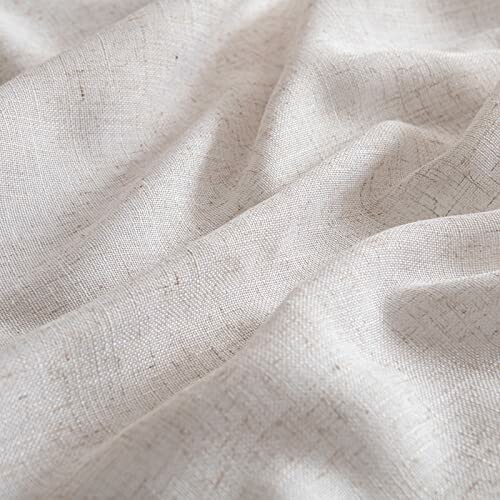 Close-up of beige textured fabric with subtle folds.