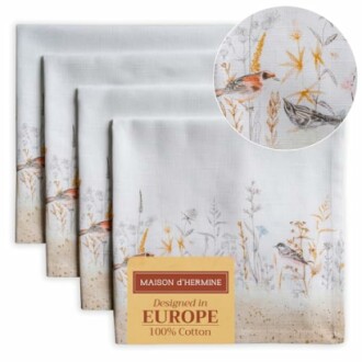 Set of cotton napkins with bird and floral design.