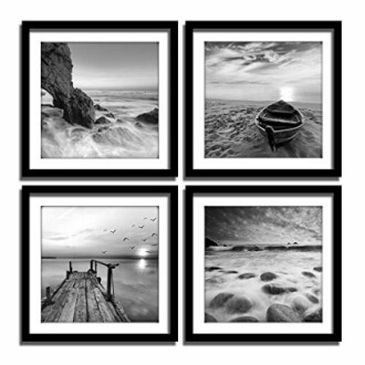 Set of four framed black and white ocean landscape photos.