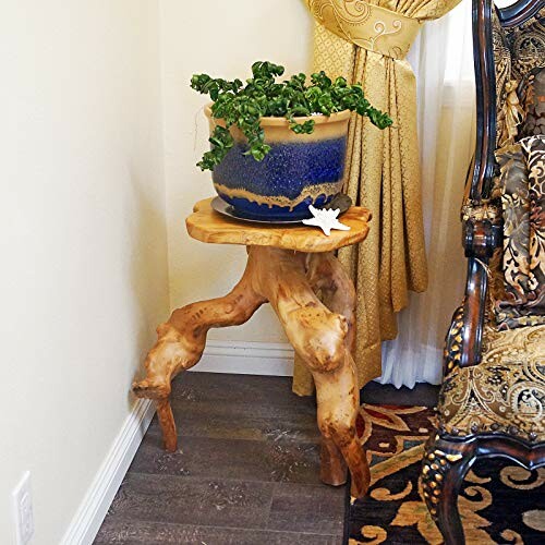 Unique wooden table with a potted plant in a corner.