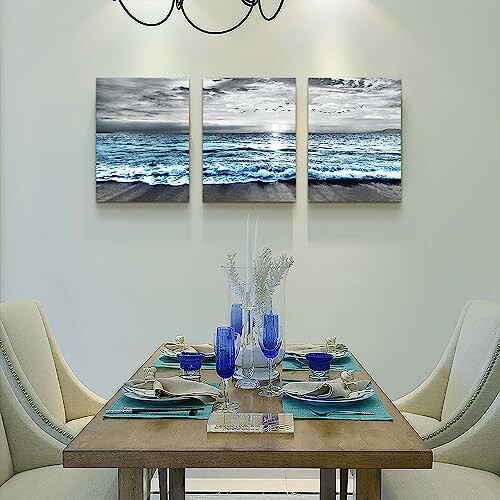 Dining room with ocean-themed wall art and elegant table setting.