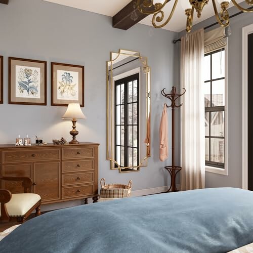 Elegant bedroom with large mirror, dresser, and wall art.