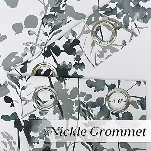 Black and white floral blackout curtains with nickel grommets.