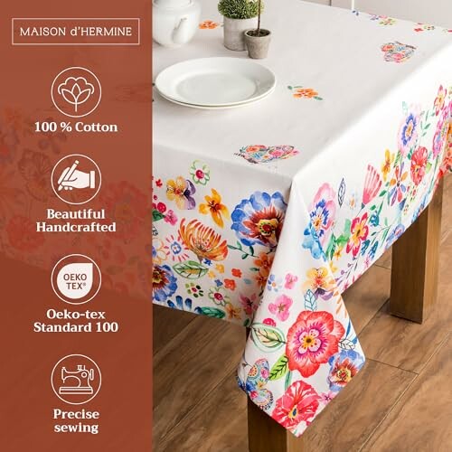 Dining table with a floral tablecloth and tableware.