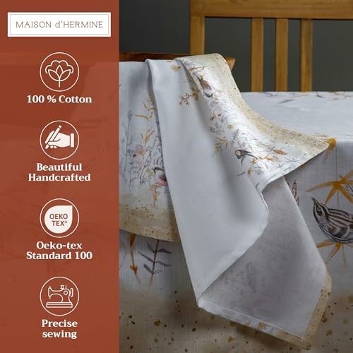 Elegant cotton tablecloth with floral design and quality certifications.