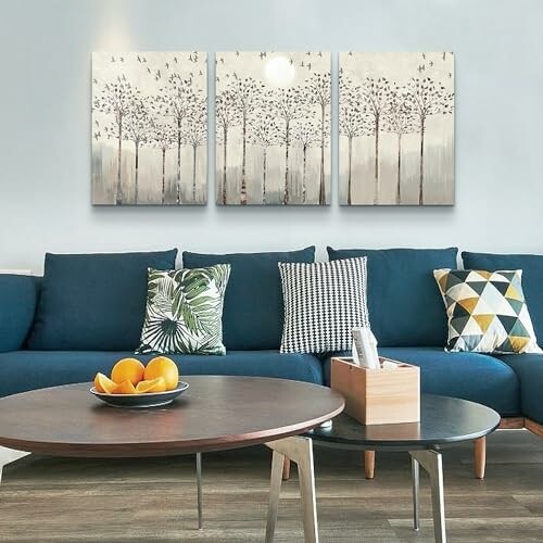 Modern living room with blue sofa, decorative pillows, and wall art.