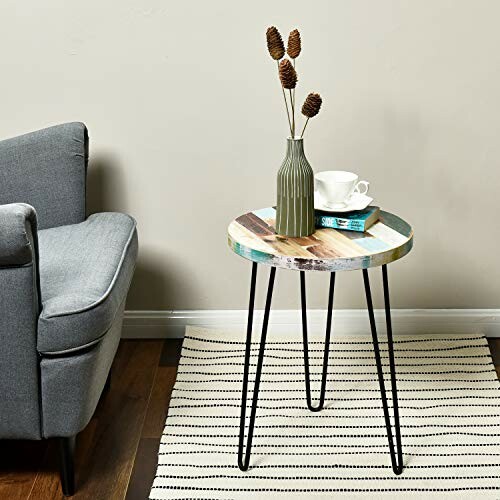 Colorful round side table with vase and cups in living room
