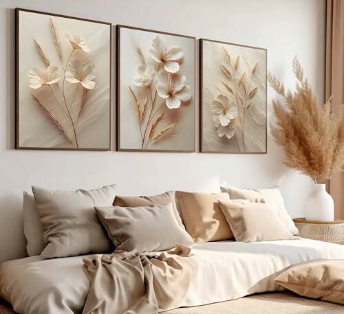 Neutral-toned bedroom with floral art and pampas grass.