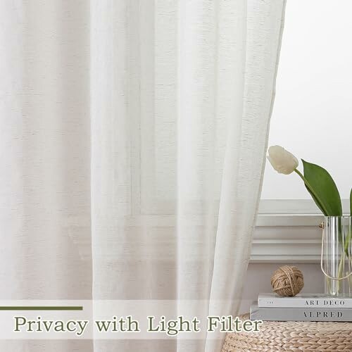 Sheer curtain with light filter effect, vase with tulip on books.