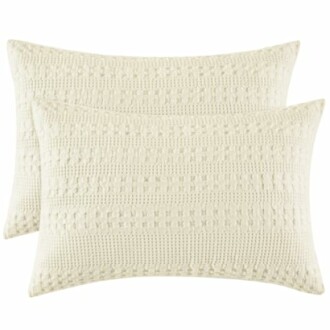 Two cream-colored textured pillows