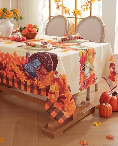 Thanksgiving table with autumn-themed tablecloth and decorations.